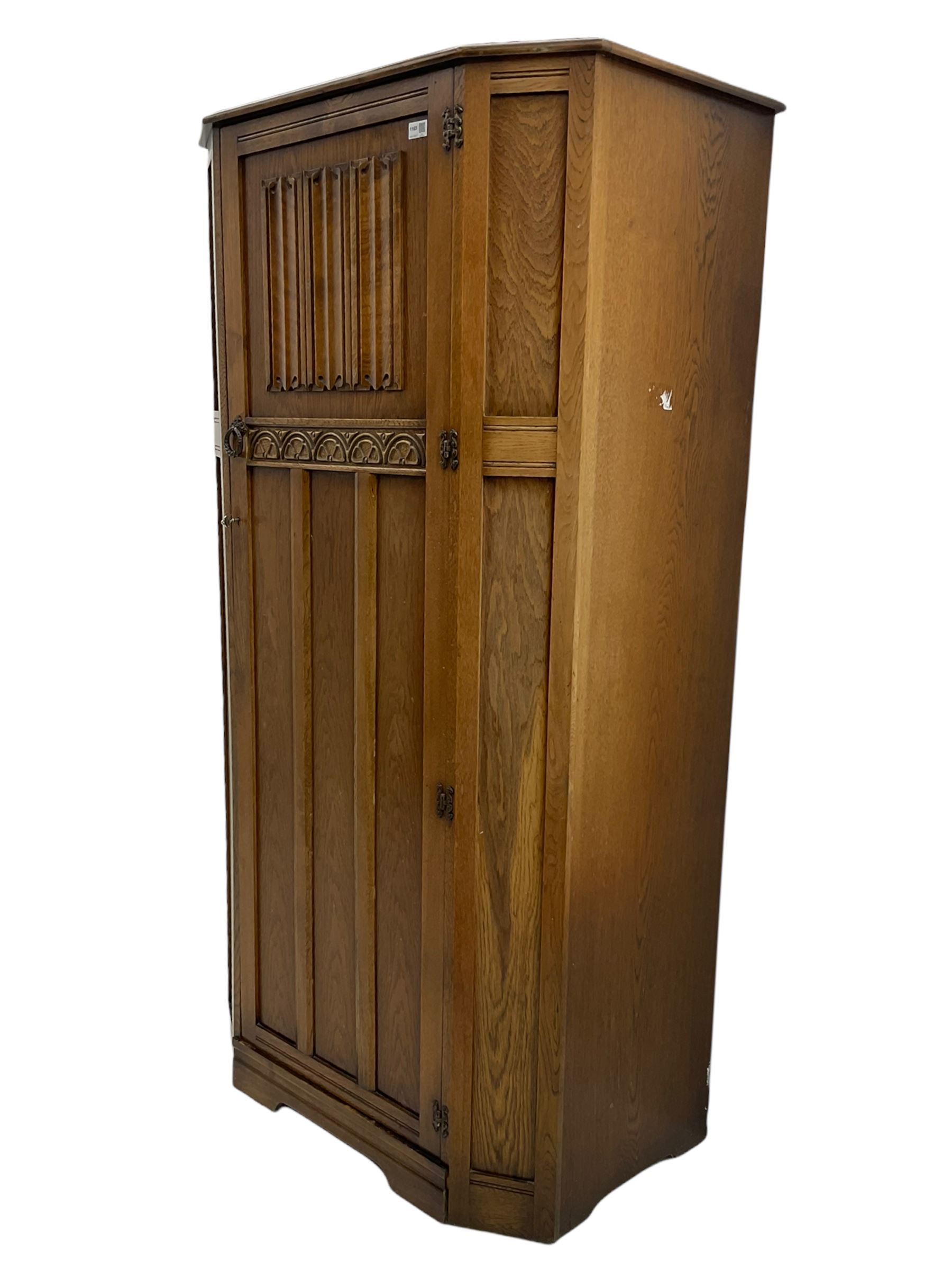 Early to mid 20th century oak hall wardrobe, single door with linenfold panel