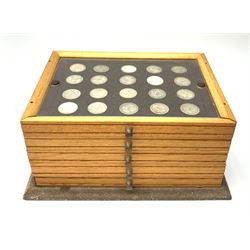 Small stacking coin cabinet, comprising seven removable layers each with protective plastic cover, containing various shilling coins including some pre 1947, H18cm