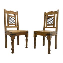 Pair of hardwood chairs, with wrought metal brackets and splat, turned front supports