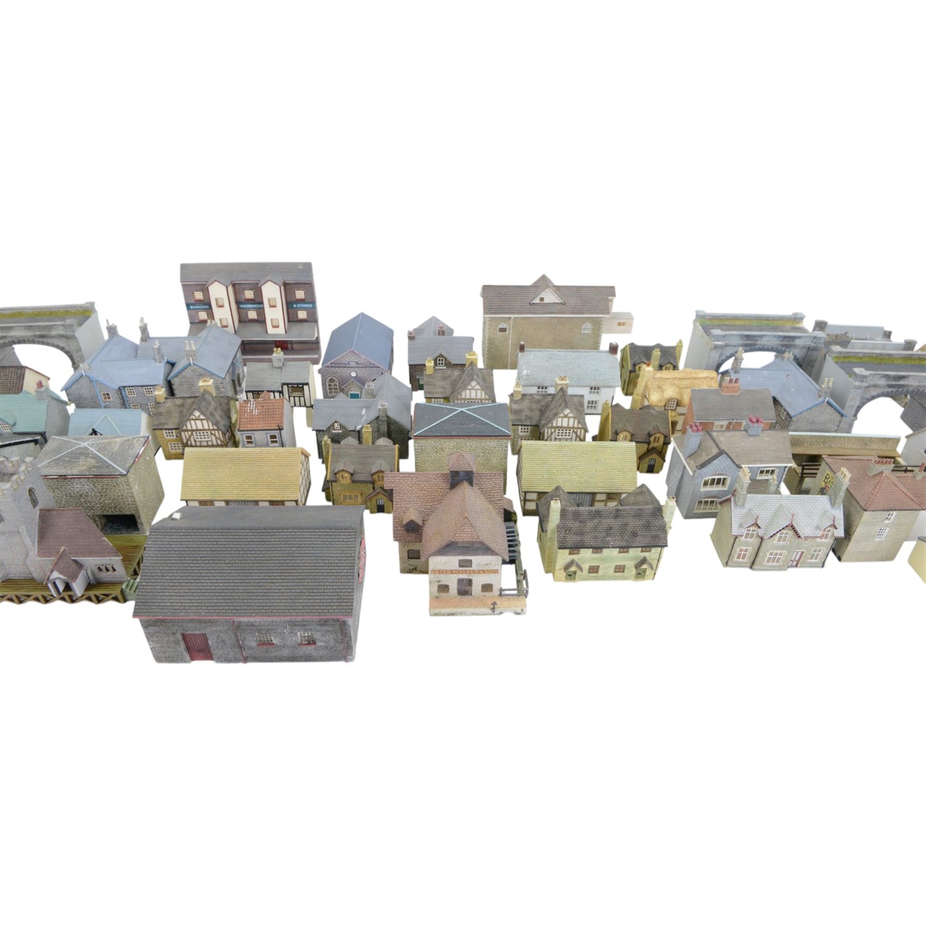 Fifty-two 00 gauge model railway trackside buildings, comprising forty-two Hornby Skaledale examples and ten Bachmann Scenecraft examples, including pubs, cottages, bridges, etc, all unboxed