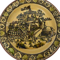 Wetheriggs Pottery of Penrith slipware Ivanhoe charger, the centre depicting a pair of jousting knights, with the King and Queen looking on, with impressed marks beneath, D51cm 