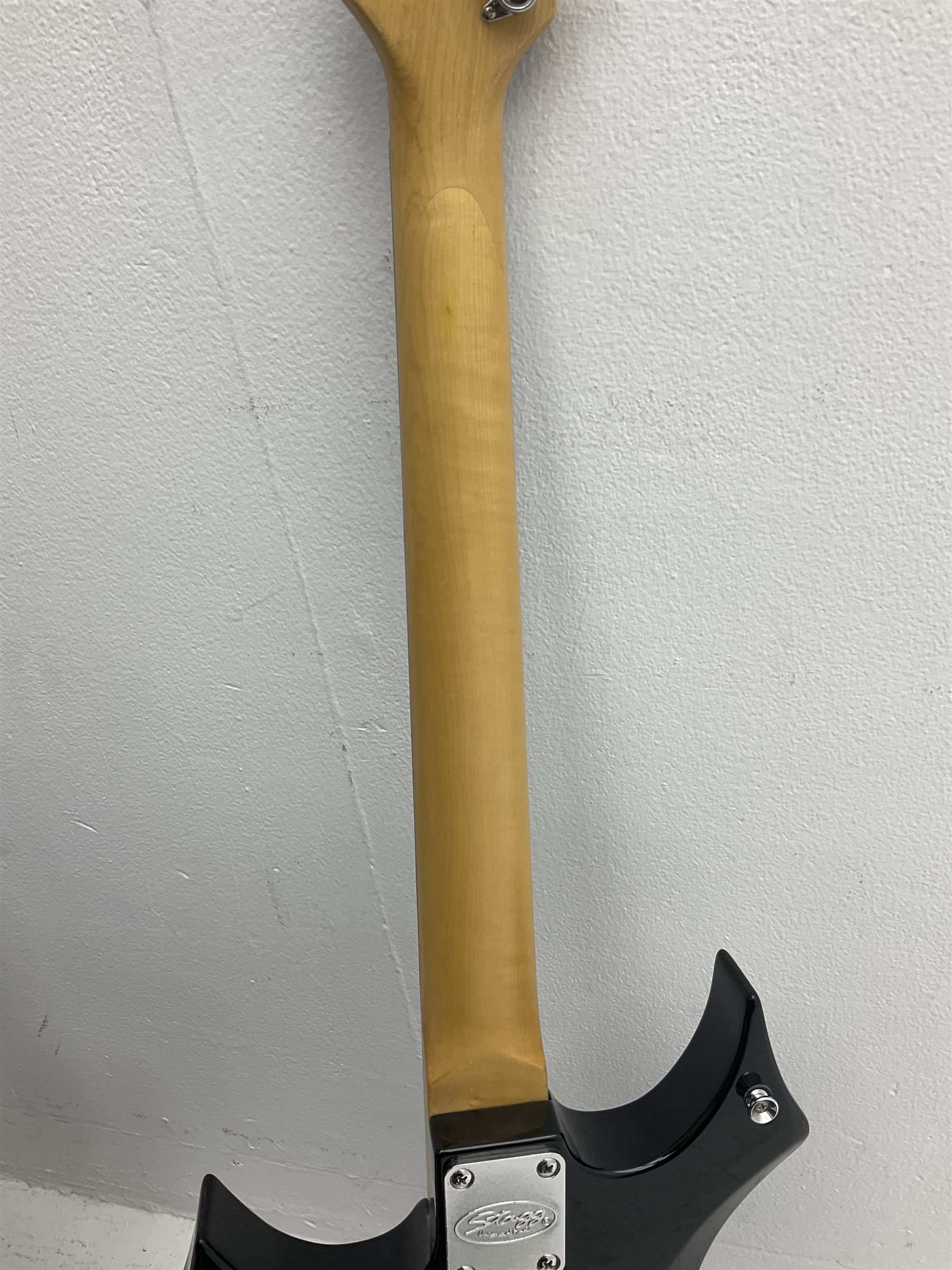 Stagg heavy metal style six-string electric guitar, finished in black with chrome tuning pegs, fret markers and humbucker pickups to bridge L106cm; and Hondo USA electric guitar with black body, ivory coloured pickguard and mother-of-pearl fretmarkers L101cm (2)   