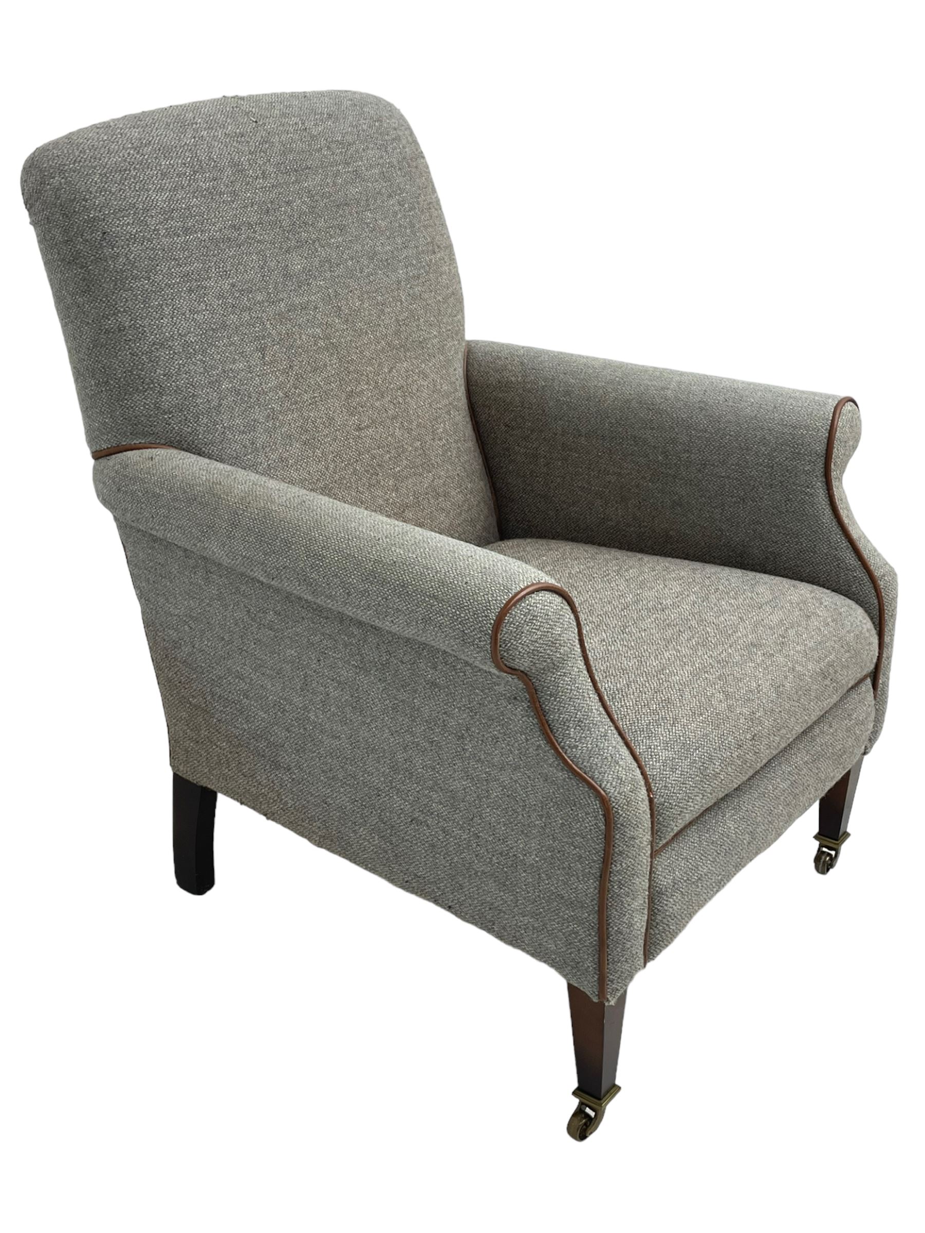 Interiors at Nine to Eleven - Edwardian design armchair, traditional shape with rolled arms, upholstered in 'Harris Tweed' fabric with leather piping, raised on square taping supports with castors