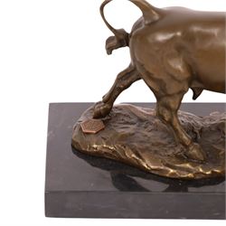 After Antoine-Louis Barye: bull upon naturalistic base, bronze, signed A Barye and bearing foundry mark, upon rectangular black stone plinth, overall H14cm L21cm