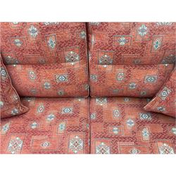 Ercol medium elm framed three seat bergere sofa, and pair of matching armchairs upholstered in red fabric