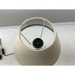 Table lamp, with a thin central stem upon a square stepped base, natural linen shade