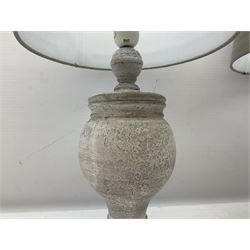 Pair of composite grey table lamps, in the form of an urn upon a circular foot, with grey linen shades