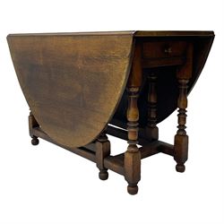 19th century oak dining table, oval drop-leaf top on gate-leg action base, turned supports united by turned stretchers, fitted with single end drawer