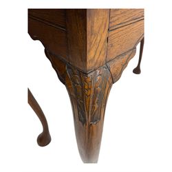 Late 19th century oak display cabinet, rectangular form with a pair of glazed doors enclosing shelves, raised on cabriole supports with carved detailing ending in claw feet