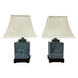Pair of Chinese blue and white bedside lamps, decorated with floral motifs, H42cm (including shades)