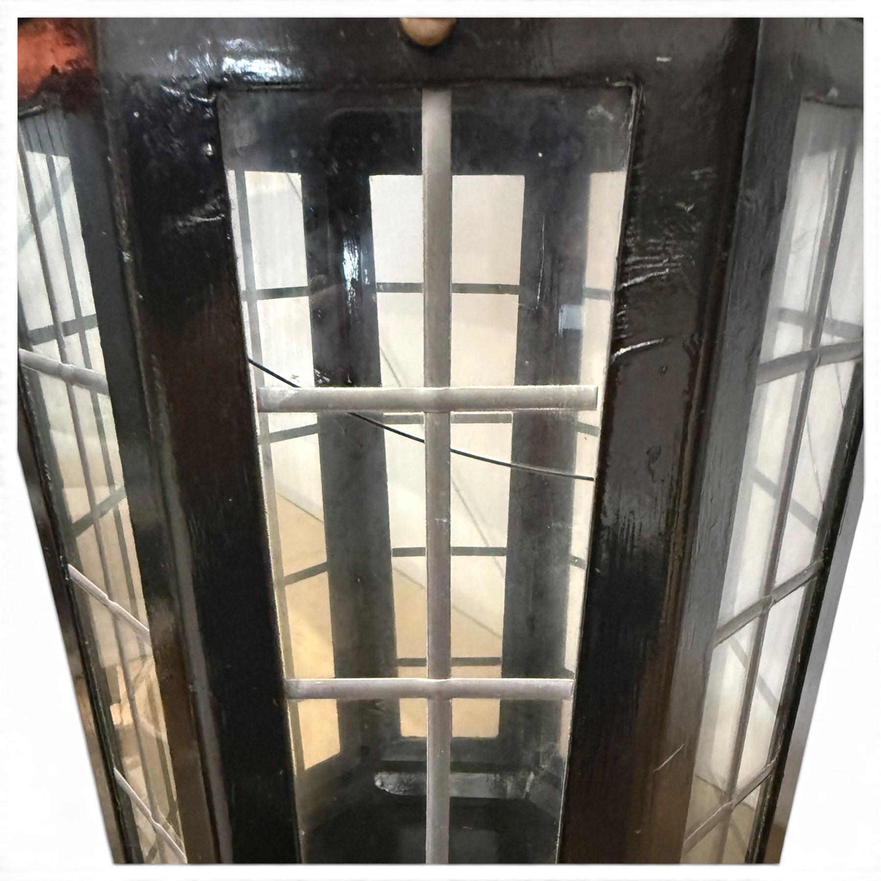 Georgian design black-painted metal octagonal hanging lantern, with brass ball finial above a hipped canopy, astragal glazed lattice panels and pendant ball terminal