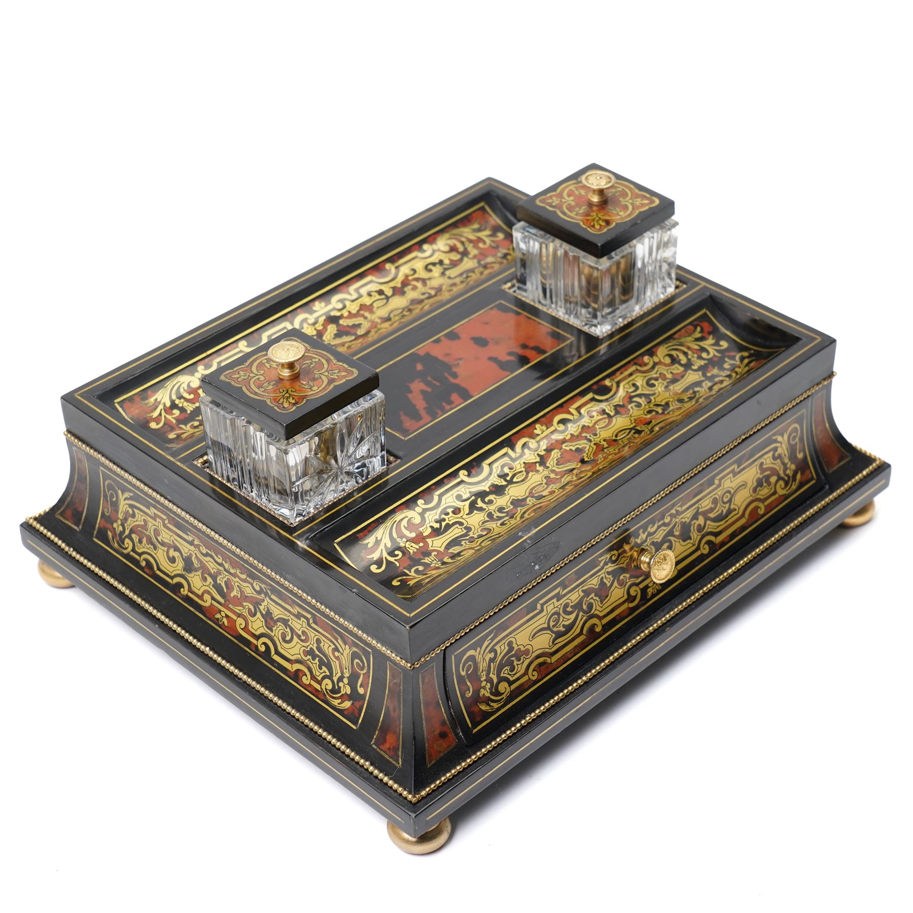 Mid 19th century Boulle inkstand in cut brass and tortoiseshell with beaded decoration with two pen trays and two inkwells on a single drawer base and compressed bun feet W32cm 