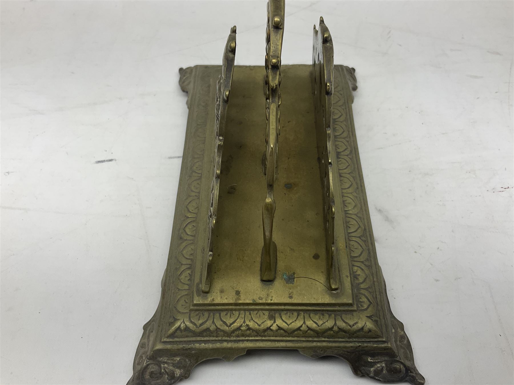 Collection of victorian and later brass desk accessories, to include a letter holder with cherub design, ink well of square form with hinged lid, brass table bell, brass casket with relief decoration, etc  