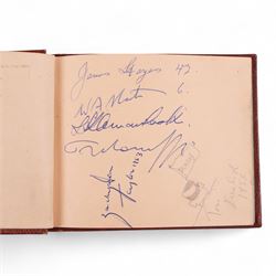 1950s autograph book, containing mostly motorcycle racing signatures, including four-time World Sidecar Champion Eric Oliver, 1952 Sidecar World Champion Cyril Smith and1955 Junior TT Champion Jack Bailey, in red leather case with gilt lettering 