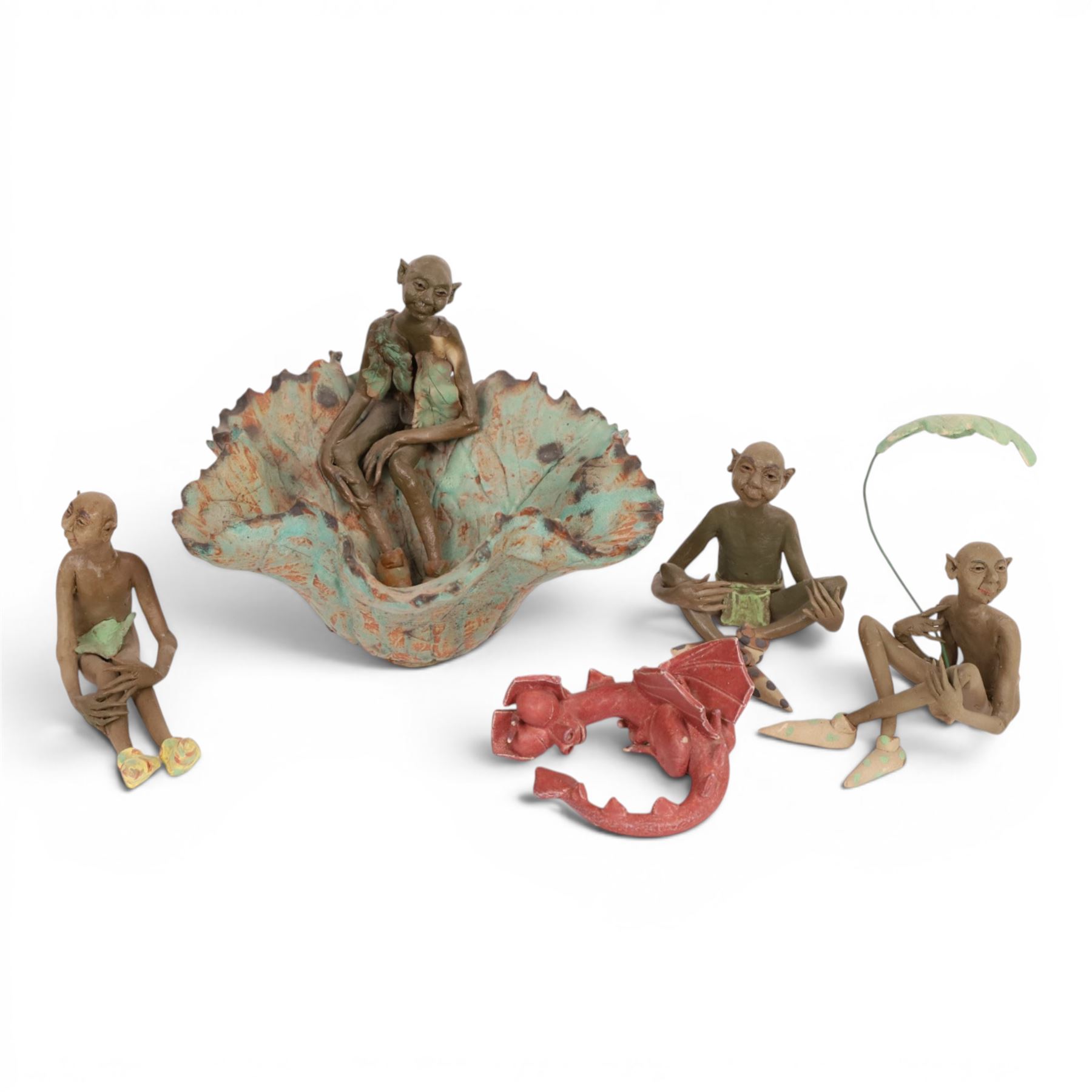 Joan Bideau dish, modelled as a leaf with seated goblin figure, together with three others  and studio pottery dragon by Jane Tudor