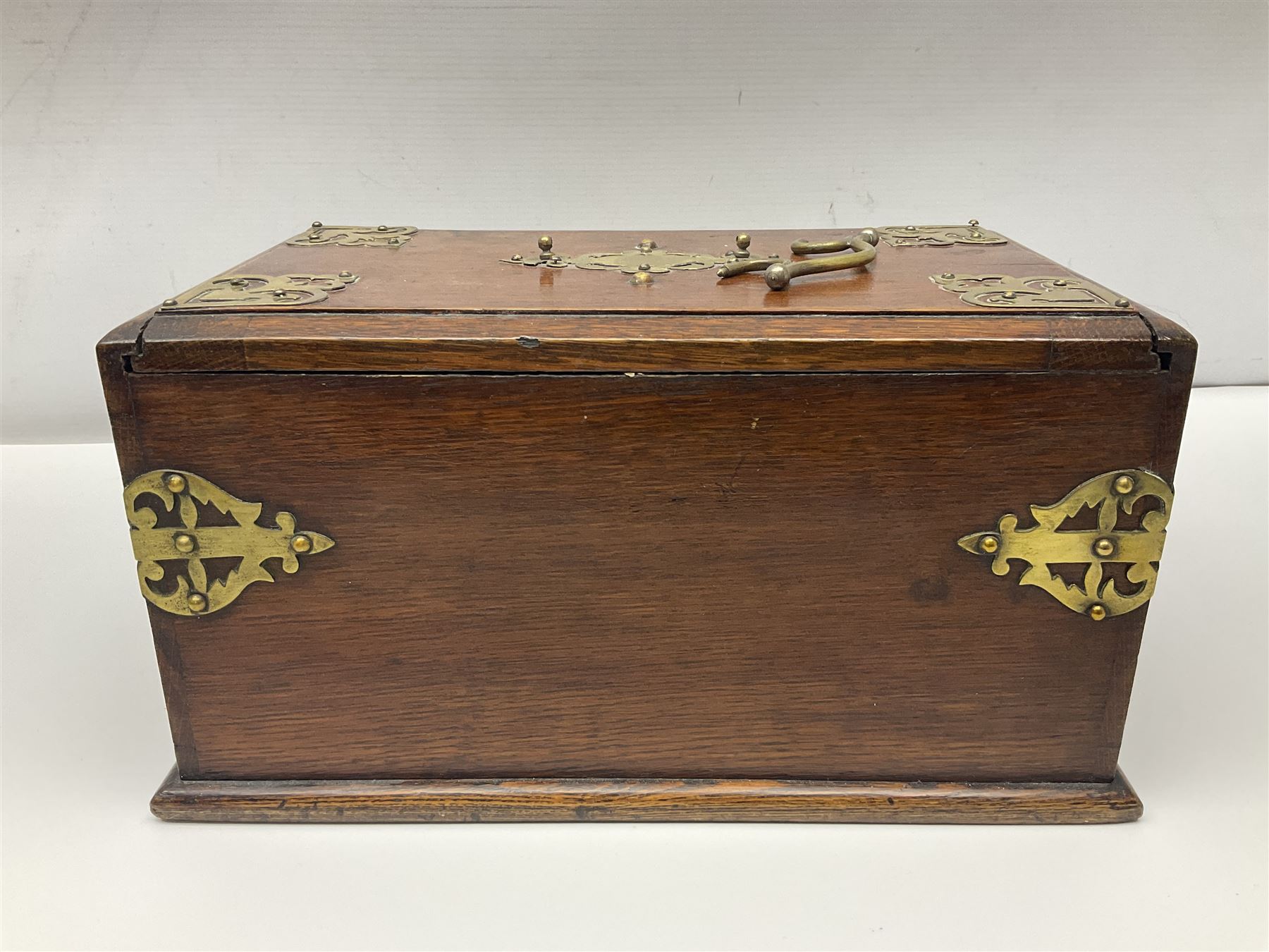 Brass mounted oak humidor, the slide action top opening to a base drawer, cedar lined with central compartment and striker, the drawer stamped Rd 107198, H17cm, D18cm