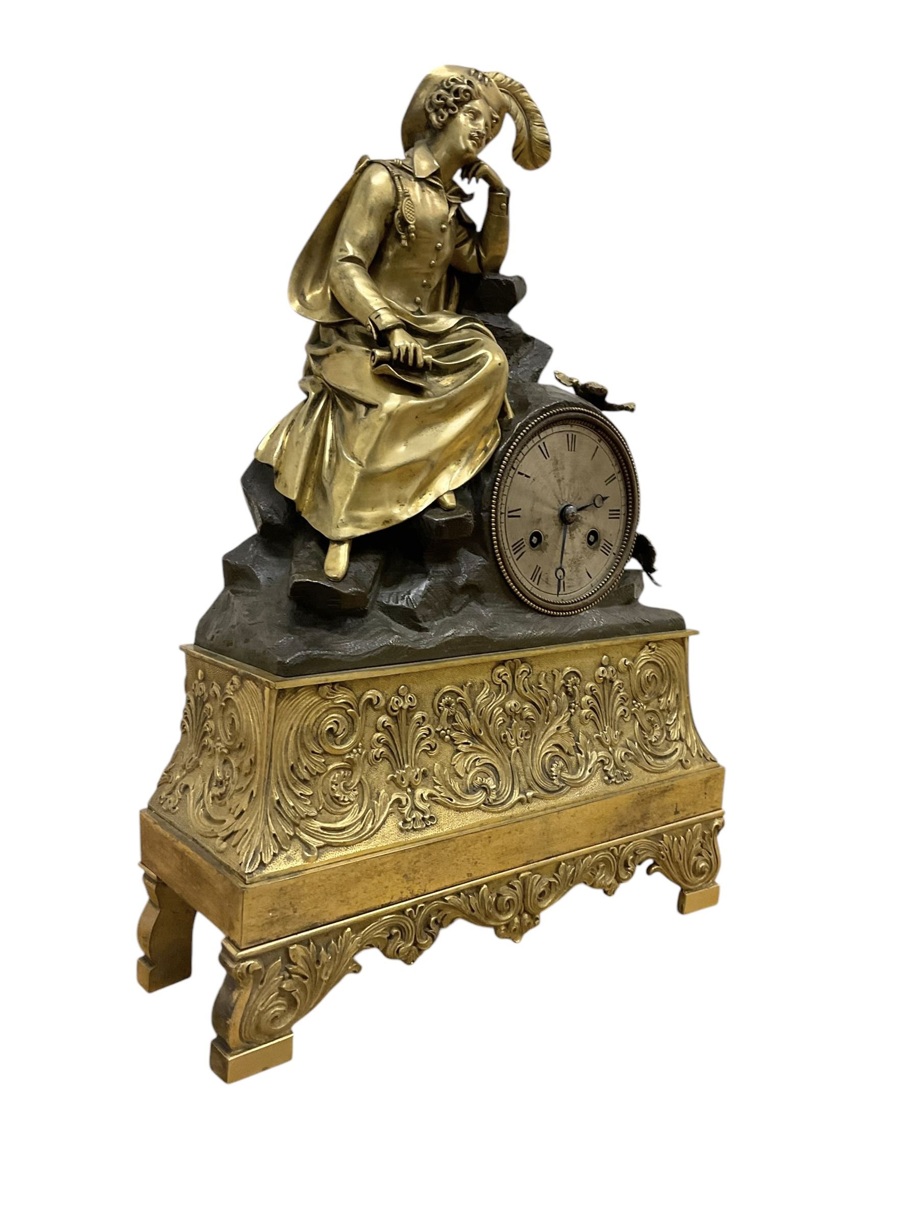French-Louis XVIII  8-day mantle clock c1820, on a rectangular gilt metal base incorporating repeating cast leaf decoration on a pierced apron and bracket feet, surmounted with a cast brass figure depicting a reclining lady in 18th century dress, Parisian drum movement with a silk suspension and unglazed silvered dial, with Roman numerals and steel moon hands, dial pinned to a countwheel striking movement, sounding the hours and half-hours on a bell. With pendulum and key.
