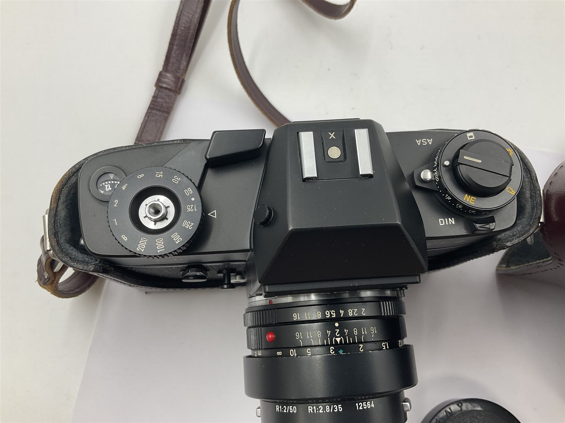 Leitz Leicaflex SL2 camera body, serial no.1387046, with 'Summicron-R 1:2/50 Leitz Wetzlar' lens, serial no. 2273397, within a leather Leitz lens hood 