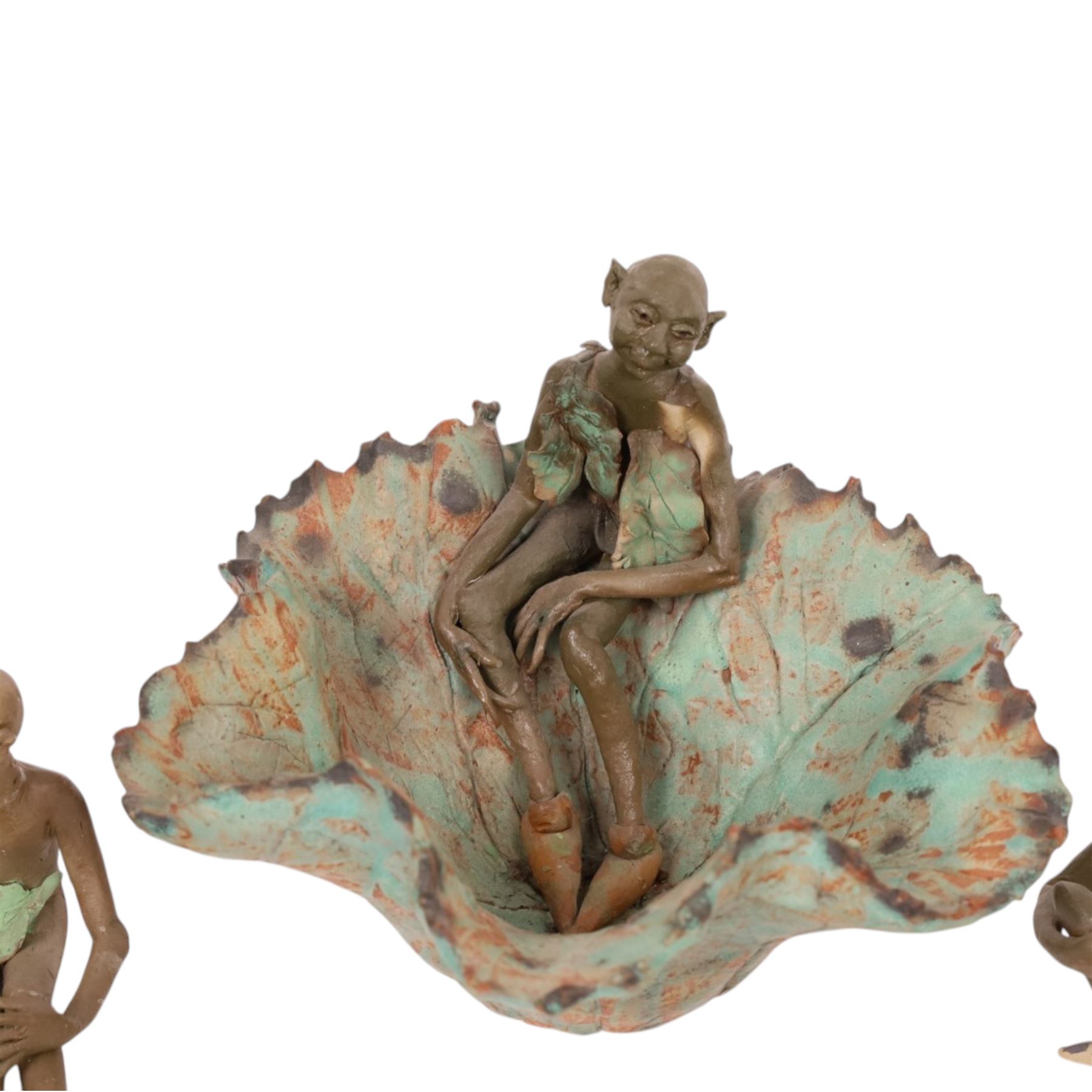 Joan Bideau dish, modelled as a leaf with seated goblin figure, together with three others  and studio pottery dragon by Jane Tudor