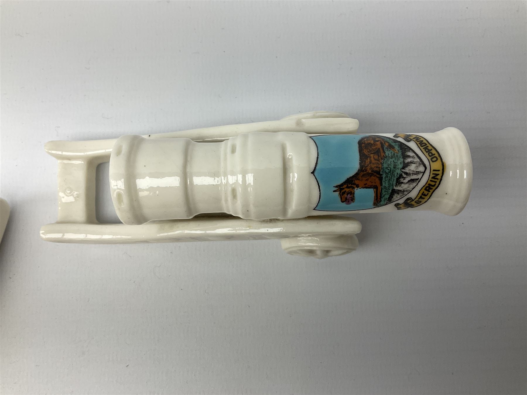 Three pieces of crested ware, comprising grenade detailed 'The Mills Hand Grenade' with Filey Crest, marked beneath Grafton China, a cannon with crest banner detailed 'Sterlini Oppidvm', marked beneath W H Goss, and a submarine with Tunbridge Wells crest, marked beneath Arcadian China 