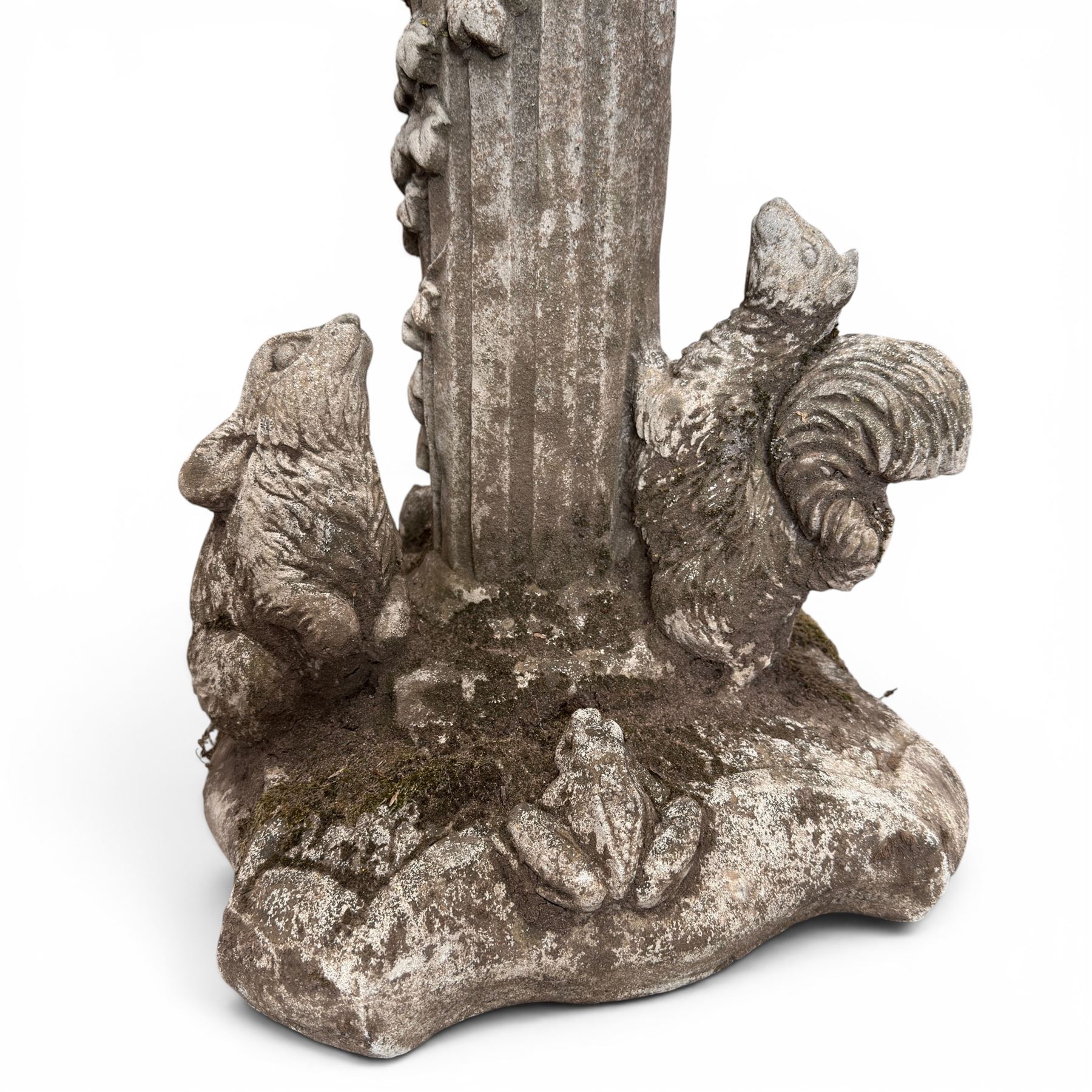 Pair of weathered composite stone garden figures, modelled as a girl and a young satyr playing the panpipes seated on column supports, the fluted columns with climbing ivy vines and surmounted animal, butterfly and other zoomorphic motifs