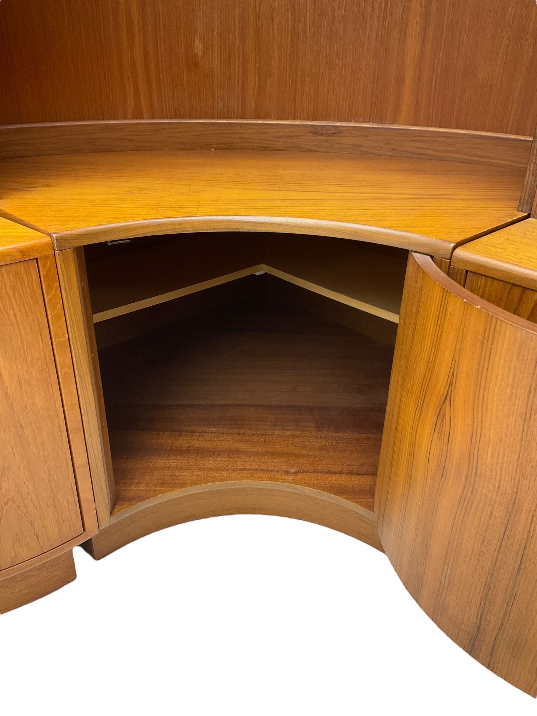 G-Plan - teak three sectional wall unit, fitted with display cabinet enclosed by two sliding glass doors, shelves and cupboards