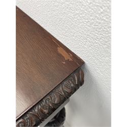 Pair early 20th century Hepplewhite style mahogany D-end console tables, the curved top with foliate carved edge, fluted frieze rails carved with flower heads, turned and reeded acanthus supports with recessed castors