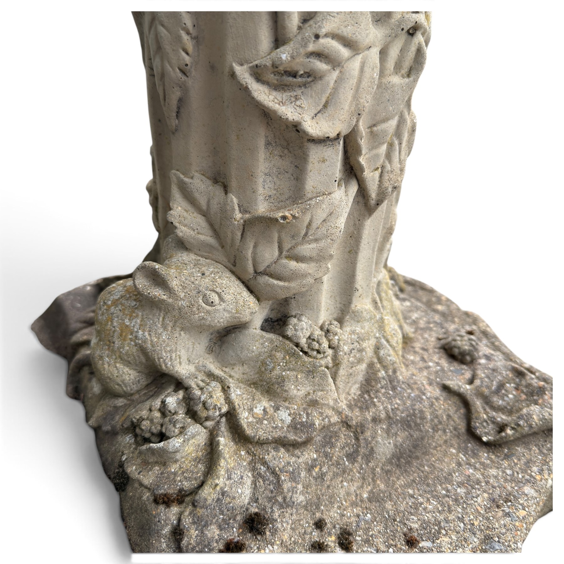 Weathered cast stone birdbath, the kylix shaped bowl with fluted body, raised on a fruiting foliate vine decorated fluted pedestal with upper knop and bird and fieldmouse motifs, shaped square base with scroll feet