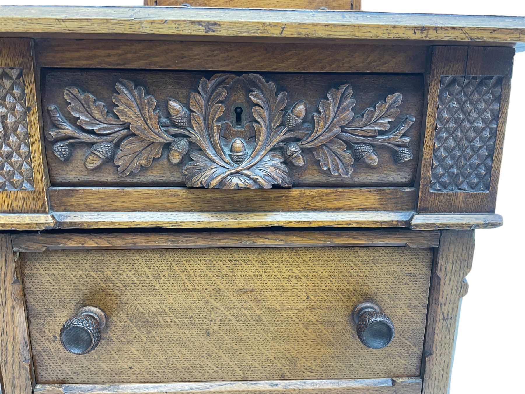 Late 19th century heavily carved oak twin pedestal desk, rectangular top with two raised trinket or correspondence structures each with three drawers, rectangular top over three frieze drawers carved with acorn and oak leaf decoration, each pedestal with three drawers with acorn husk shaped handles