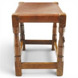 Mouseman - 1940s dark oak dressing table stool, the rectangular top with deep-tan leather seat, raised on octagonal supports united by box stretcher, with carved mouse signature, by the workshop of Robert Thompson of Kilburn