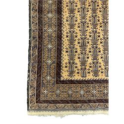 Persian pale ground rug, the field decorated with repeating plant motifs, the border with geometric design 