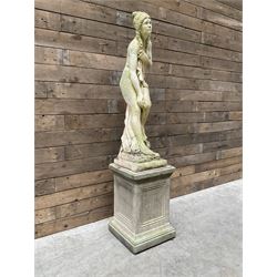 Cast stone garden figure of a bathing lady, raised on square plinth