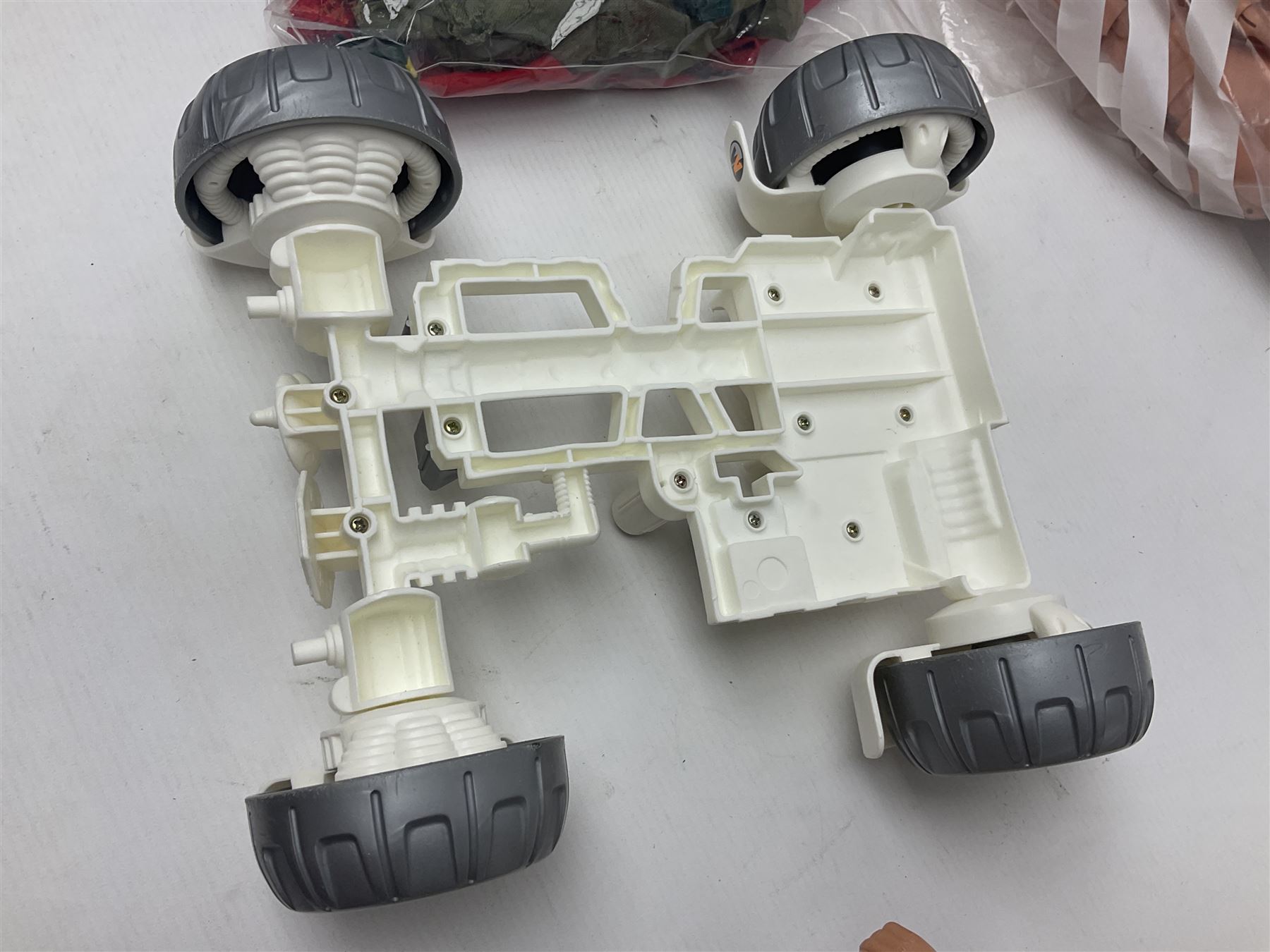 Action Man - large collection of 1960s and later figures and accessories including Spaceman with ATLRV vehicle; two figures marked 'Made in England by Palitoy under licence from Hasbro 1964'; twenty-five assorted weapons; radio backpacks; kit bags; twenty-one pairs of boots; football boots and snow shoes; metal diver's boots and three pairs of flippers; two pairs of jackboots; roller skates; various tunics, trousers, flying suits, jumpers, belts etc; twenty helmets, berets, busby, kepis, submariner etc; and quantity of other accessories