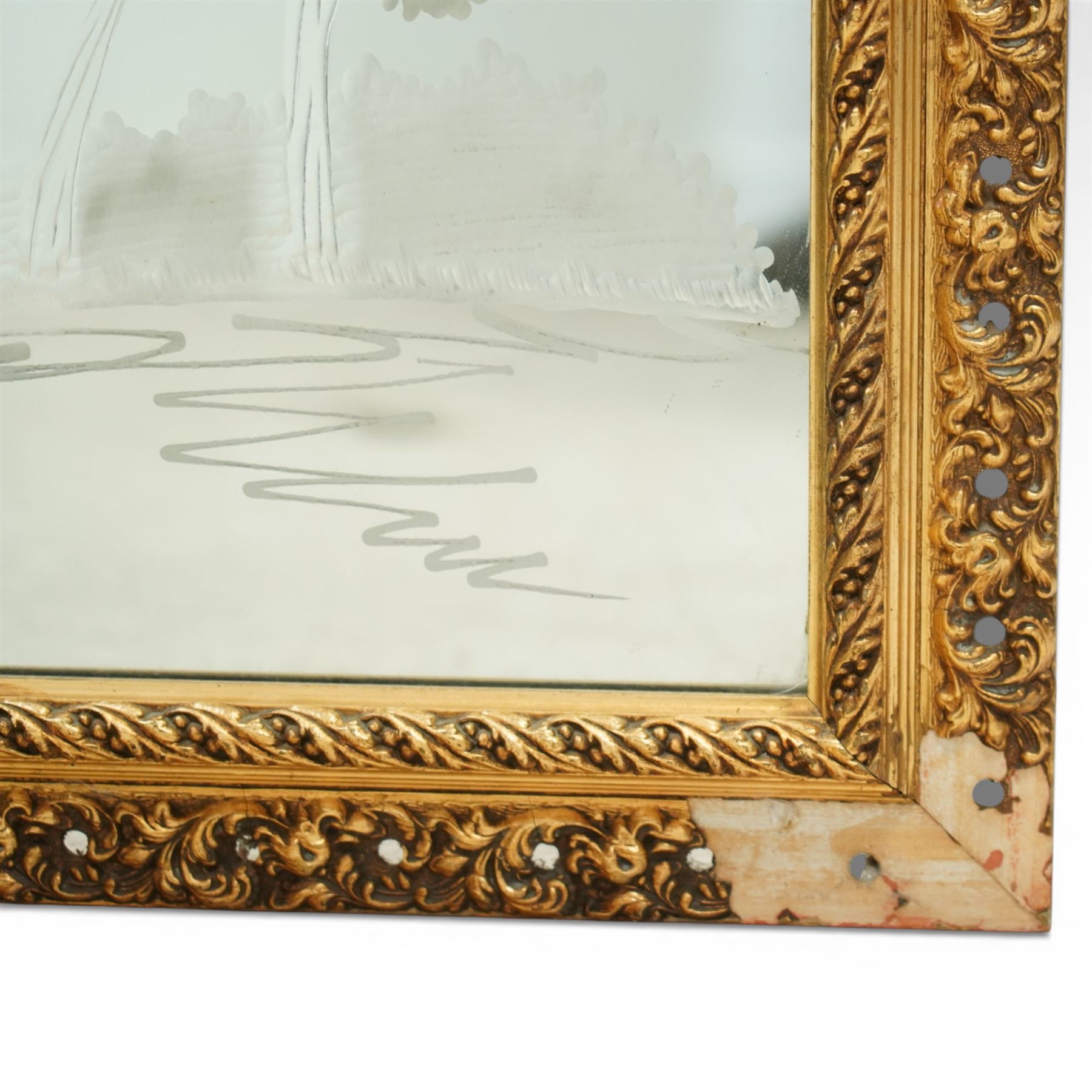 20th century giltwood and gesso wall mirror, rectangular form with pierced foliate and scroll moulded frame, rope twist inner moulding, enclosing an engraved mirror plate decorated with a horse drawn carriage and stylised trees