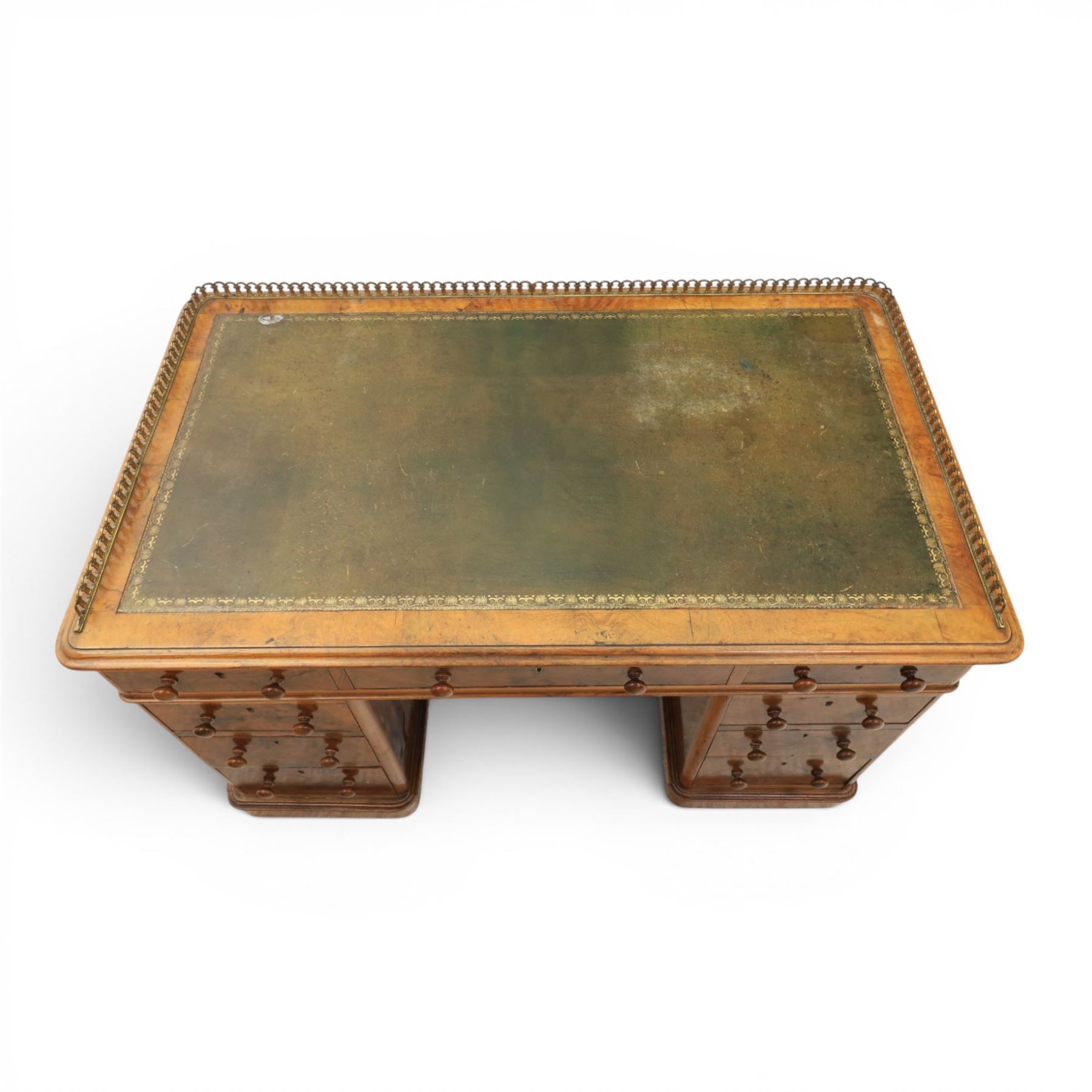 Victorian figured walnut twin pedestal desk, brass galleried top with inset tooled green leather writing surface, above three frieze drawers, raised on two pedestals with three drawers, on plinth bases above castors