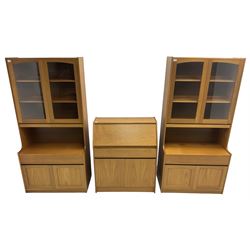 Sutcliffe of Todmorden - pair of teak wall units, fitted with two glazed doors over drawer and double cupboard (W86cm, D45cm, H198cm); and a matching fall front bureau (W84cm, D41cm, H100cm)