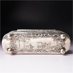 19th century continental silver box of oval design , the hinged cover with swing handle embossed with sailing ships, castle etc, the base decorated with horse and cart in rural landscape and the sides with a hunting scene on ball feet L15cm
