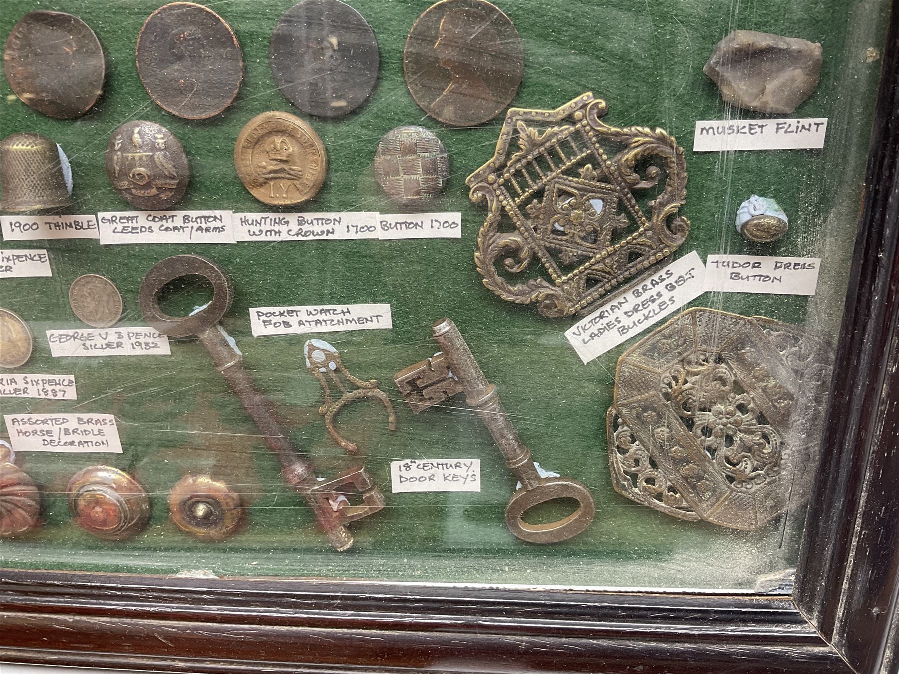 Collection of metal detecting finds and antiquities, housed on five display boards and some loose, to include coins, keys, axe head etc 