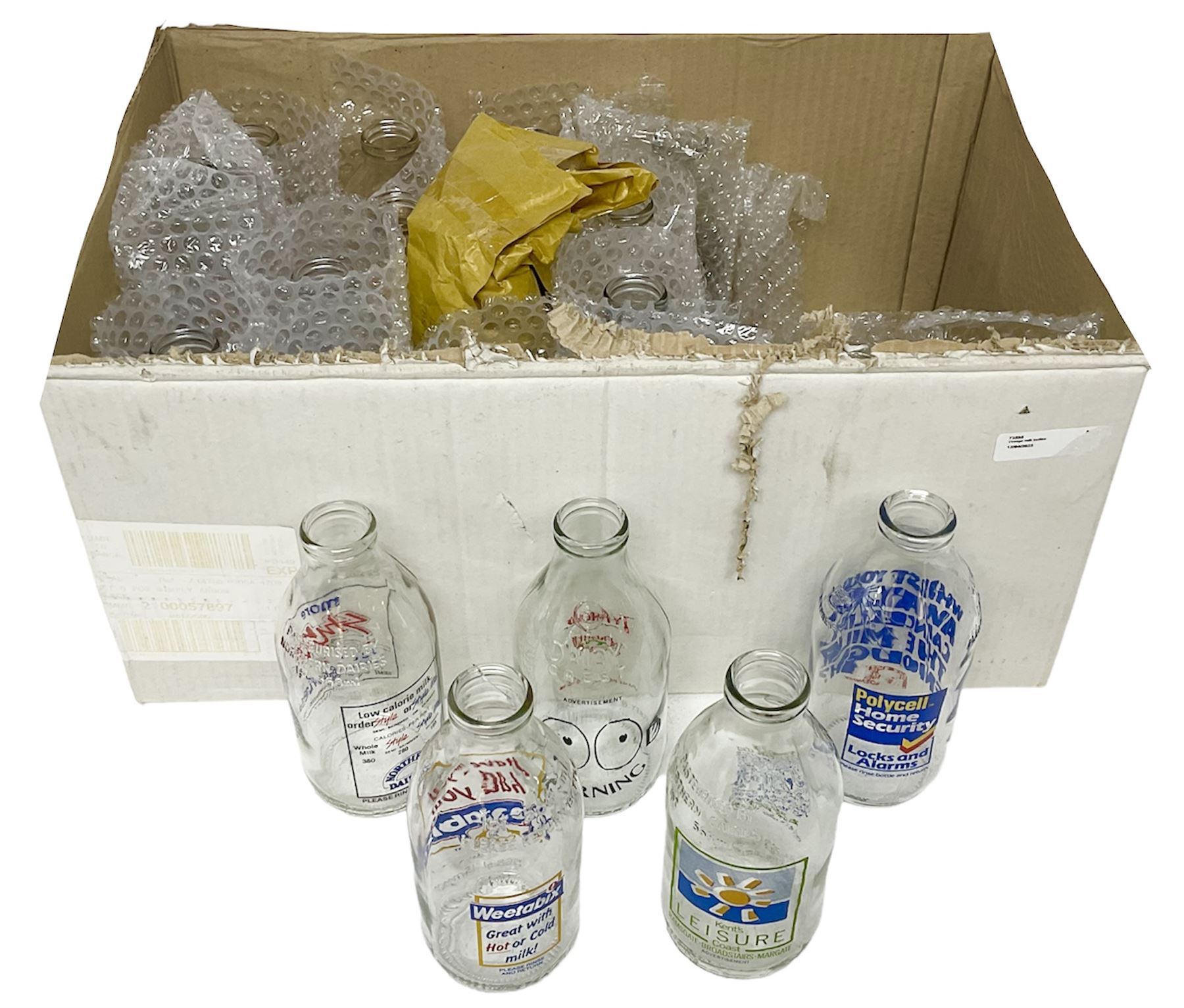 Twenty one vintage advertising milk bottles