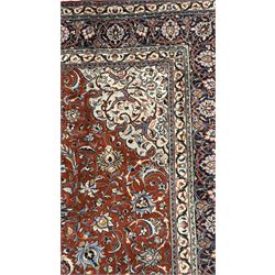 Central Persian Sarouk dark indigo and crimson ground rug, the medallion, field and spandrels decorated with repeating floral Herati motifs, the border decorated with scrolling branches and palmettes with small floral motifs, floral pattern guard stripes