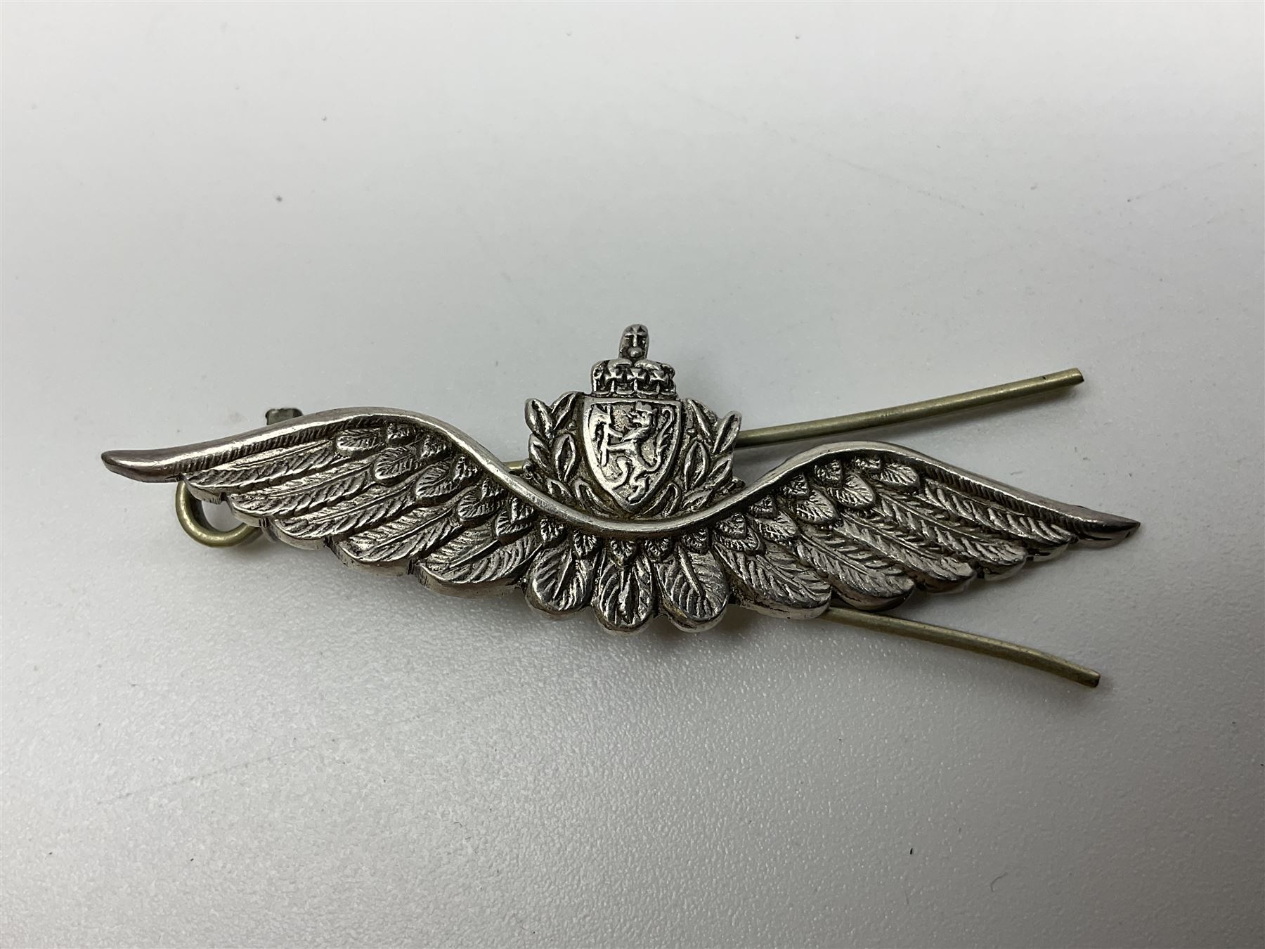 Popski's Private Army sterling silver cap badge; and two silver sweetheart brooches for Highland Light Infantry as a rifle and silver gilt Glengarry badge and Army Service Corps with blue enamel; and another silver badge (4)