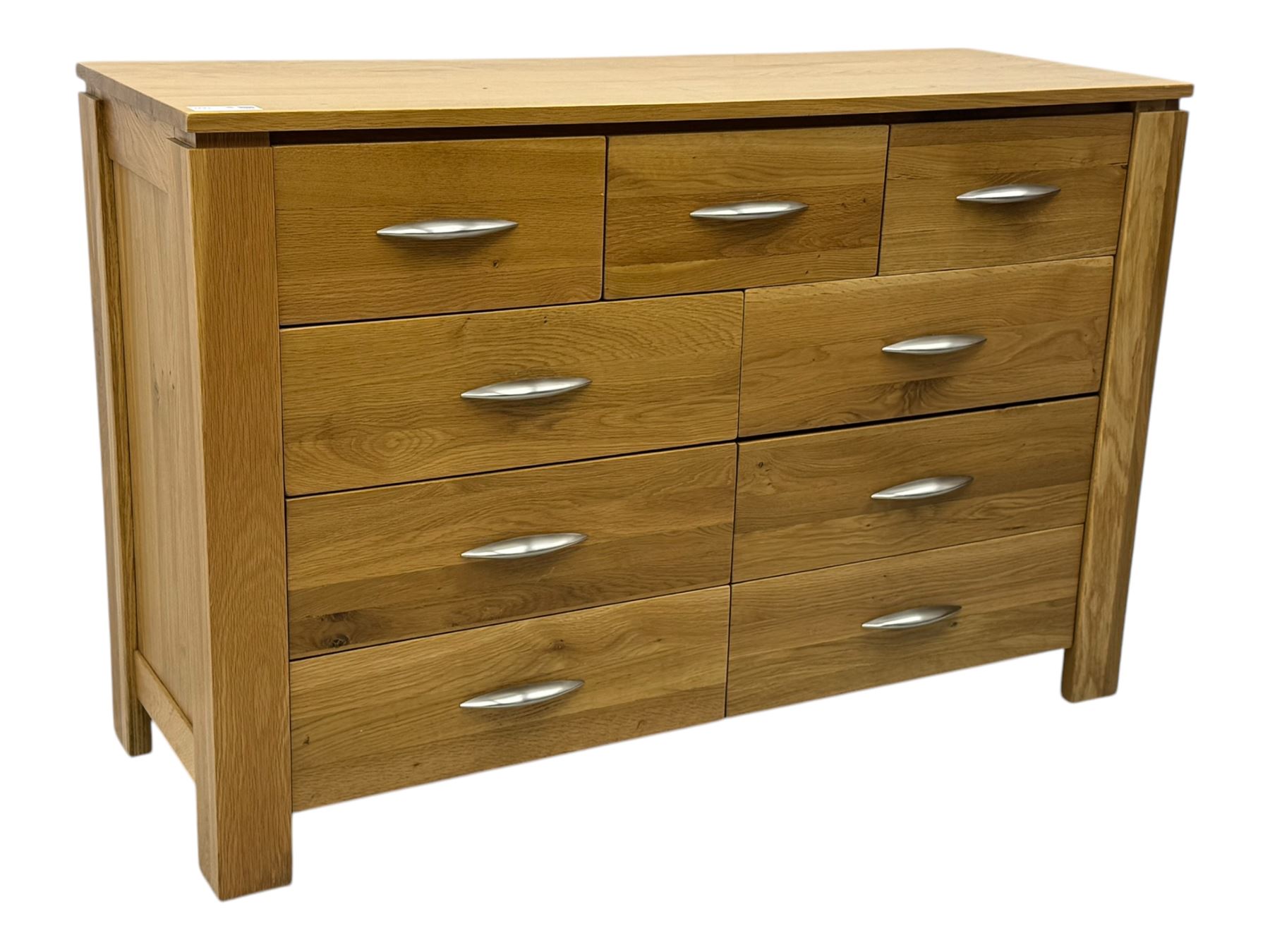 Contemporary light oak sideboard, rectangular top over three short and six long drawers each fitted with chrome handles, on plinth base