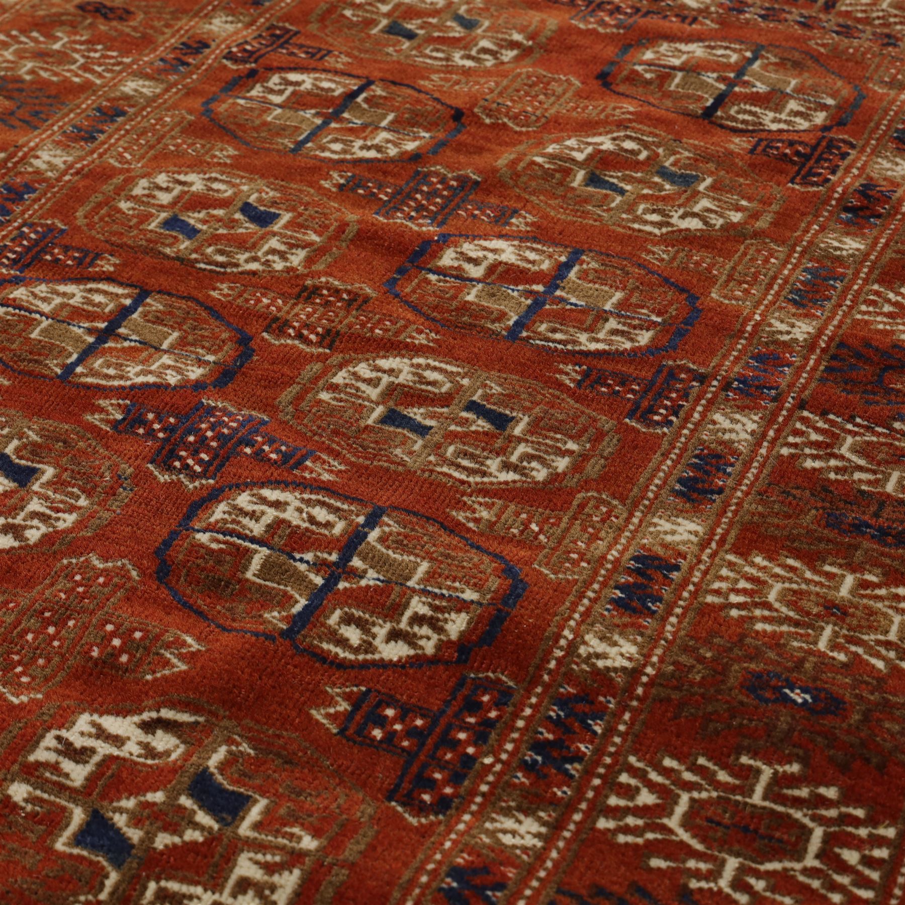 Tekke Turkman rug, madder red field decorated with repeating rows of octagonal guls, framed by multiple geometric borders, 86x133cm and an Anatolian flatweave kilim, 95x140cm, (2)