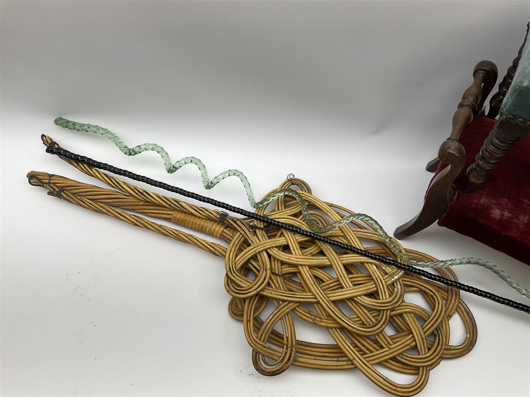 Victorian beadwork footstool with two other wooden upholstered footstools, one with turned bobbin legs, two Victorian glass frigger canes, one of twisted spiral form, and three carpet beaters