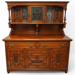 Early 20th century golden oak dresser sideboard, superstructure with three stained and lea...