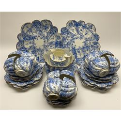 An Edwardian Chapman teaset, of lobed form decorated with blue transfer printed foliate decoration, comprising twelve cups, twelve saucers, nine side plates, and two cake plates. 