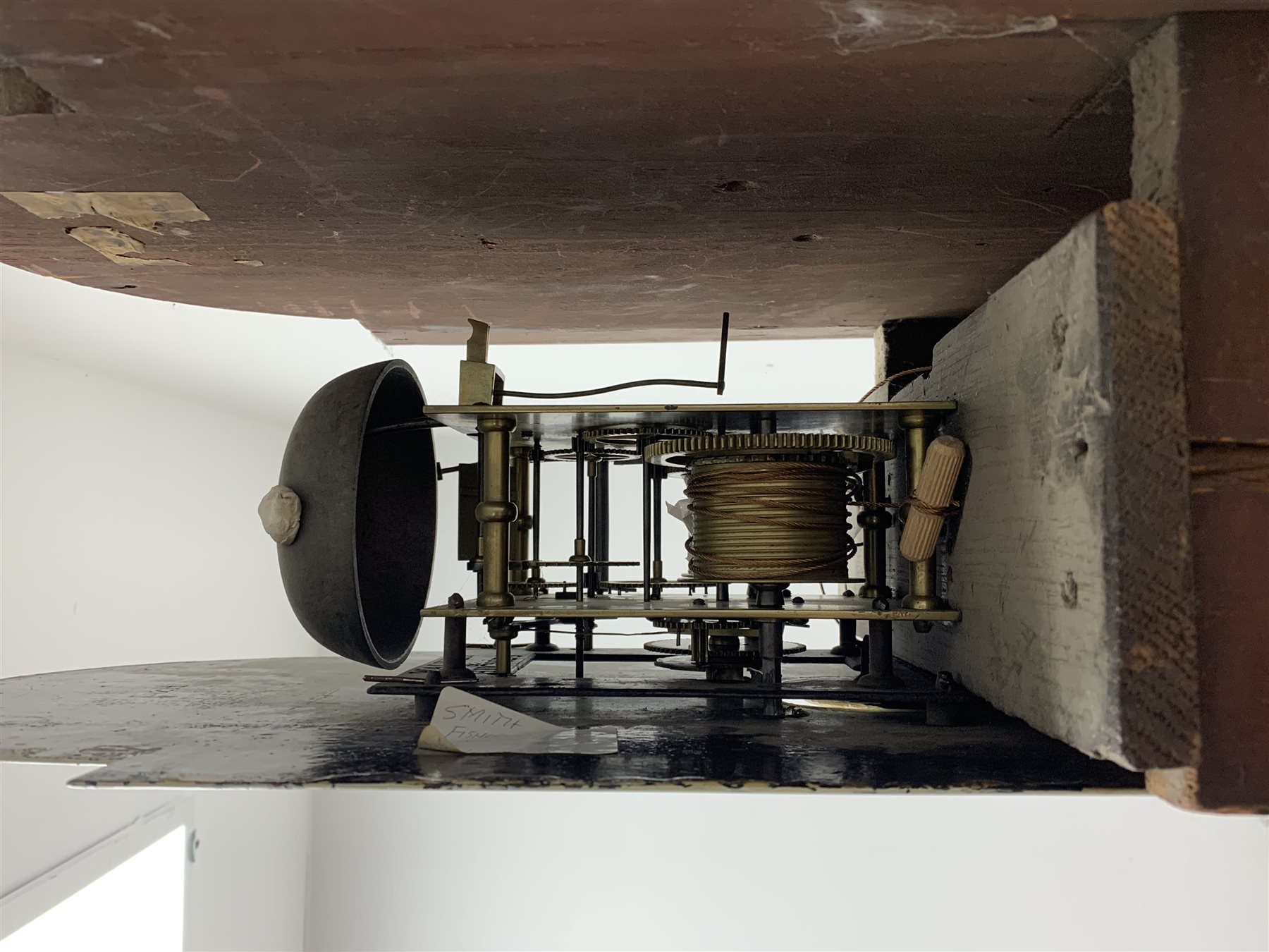 George III mahogany longcase clock, the hood with stepped moulded arch pediment above glazed door, fret work grille to each side, figured trunk door and base, enamel Arabic dial painted with country house scene and floral spandrels signed 'S. Wright, Watford', subsidiary seconds dial and date aperture, eight day movement striking the hours on bell, H212cm (two weights and pendulum)