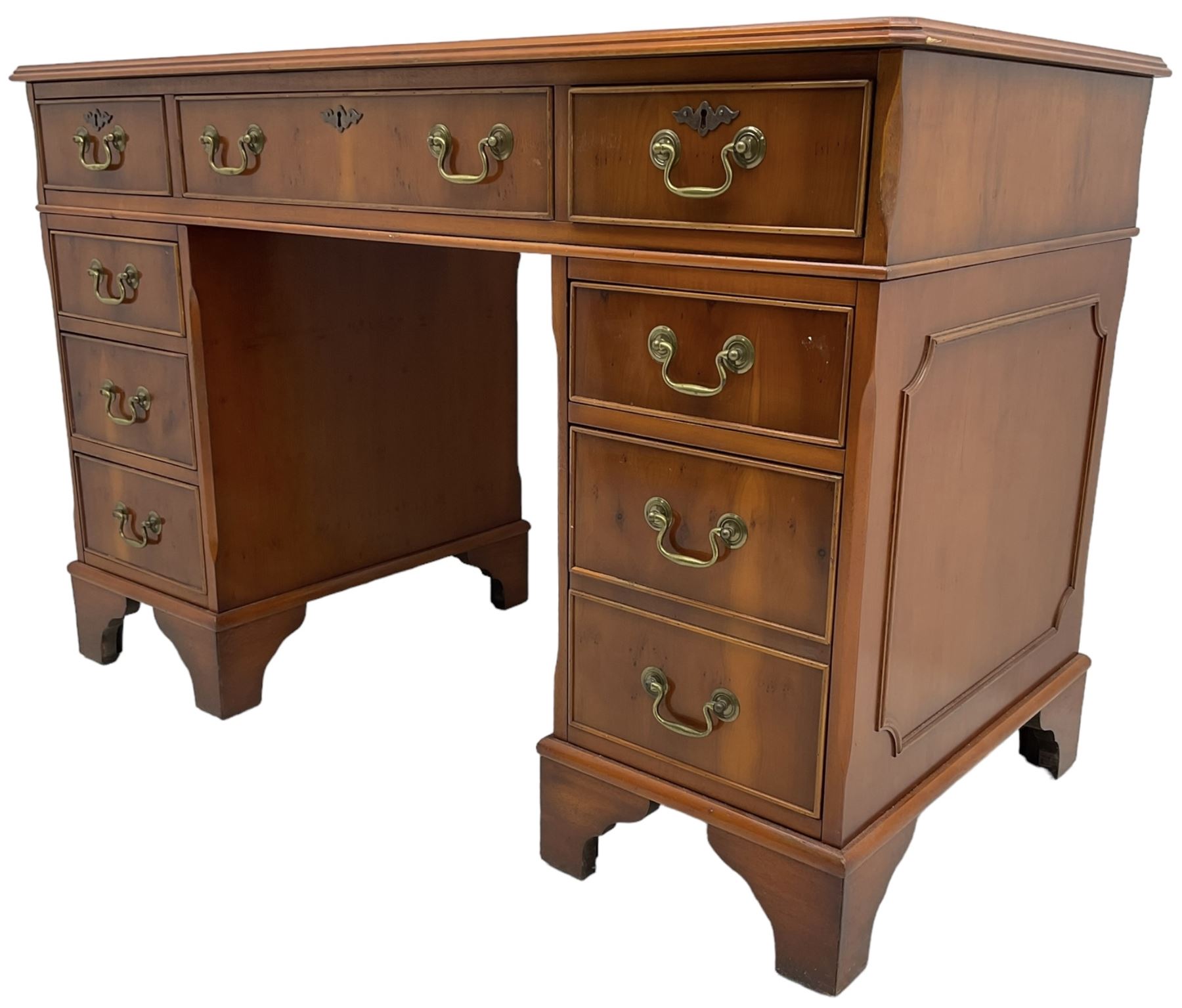 Georgian design yew wood twin pedestal desk, rectangular top with green leather inset writing surface, fitted with nine cock-beaded drawers, on bracket feet