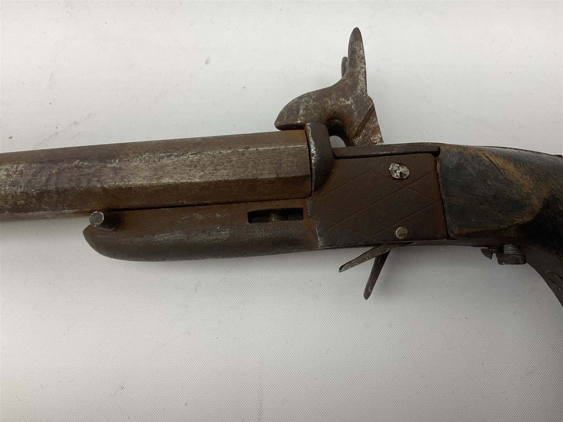 19th century Belgian 9mm side-by-side double barrel pin-fire pocket pistol with 11cm octagonal single block barrel, drop-down triggers and carved walnut stock L22.5cm overall