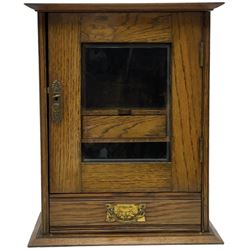 Early 20th oak smokers cabinet with the single glazed door to fitted interior having a single draw and pipe rack, H40cm pipe rack, H39cm